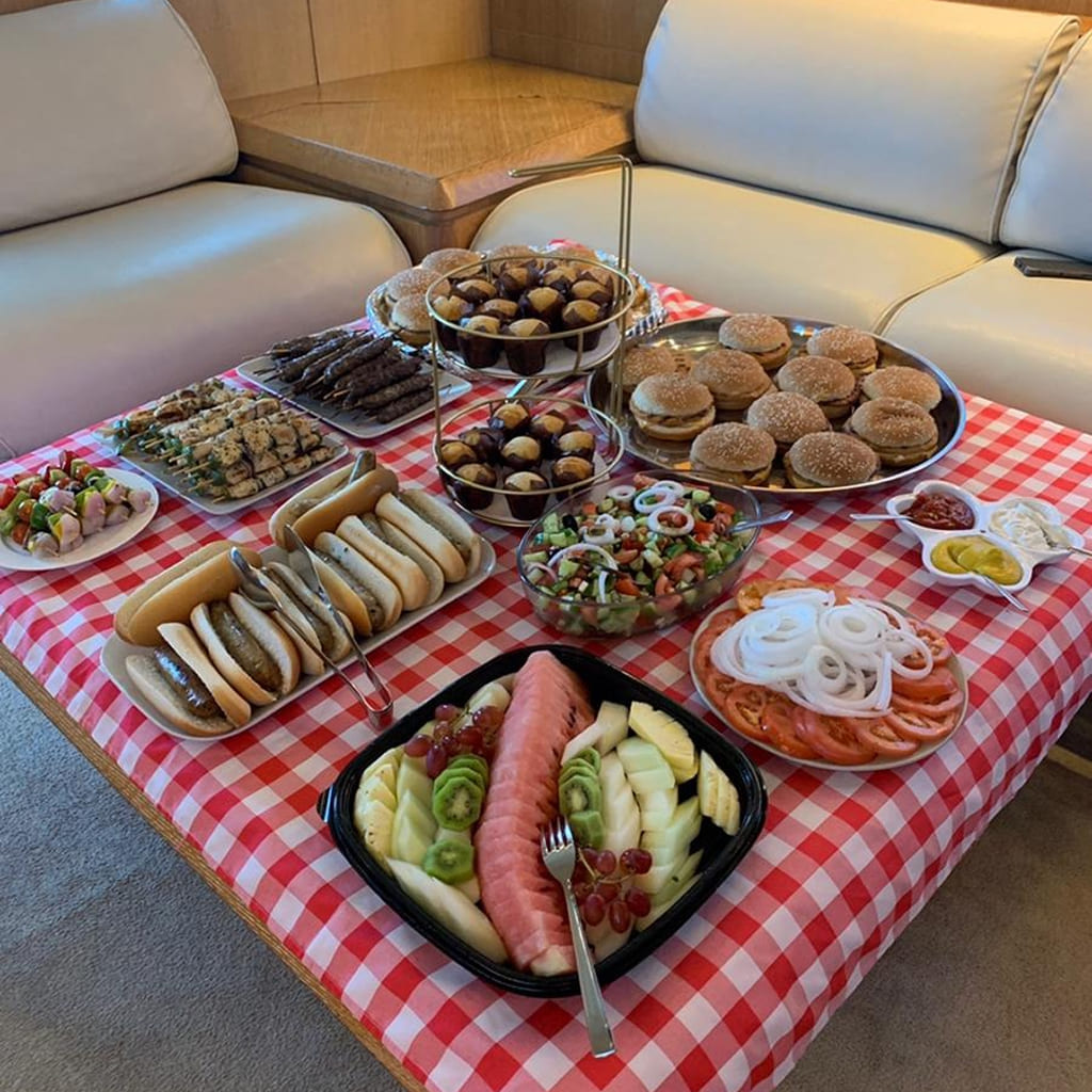 Guests dancing under party lights on Dubai shared yacht